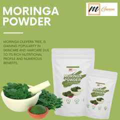 Scoop of Moringa powder on a wooden spoon