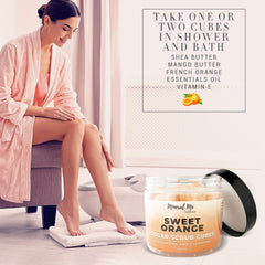 Hands applying the sugar cube scrub on damp skin