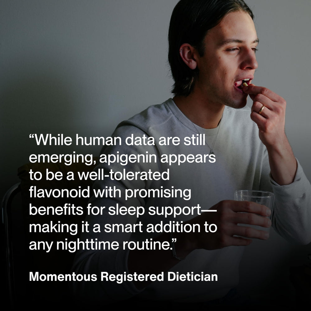 Lifestyle scene with Momentous Apigenin bottle and glass of water