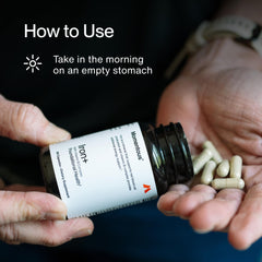 Athlete taking Momentous Iron+ supplement with water