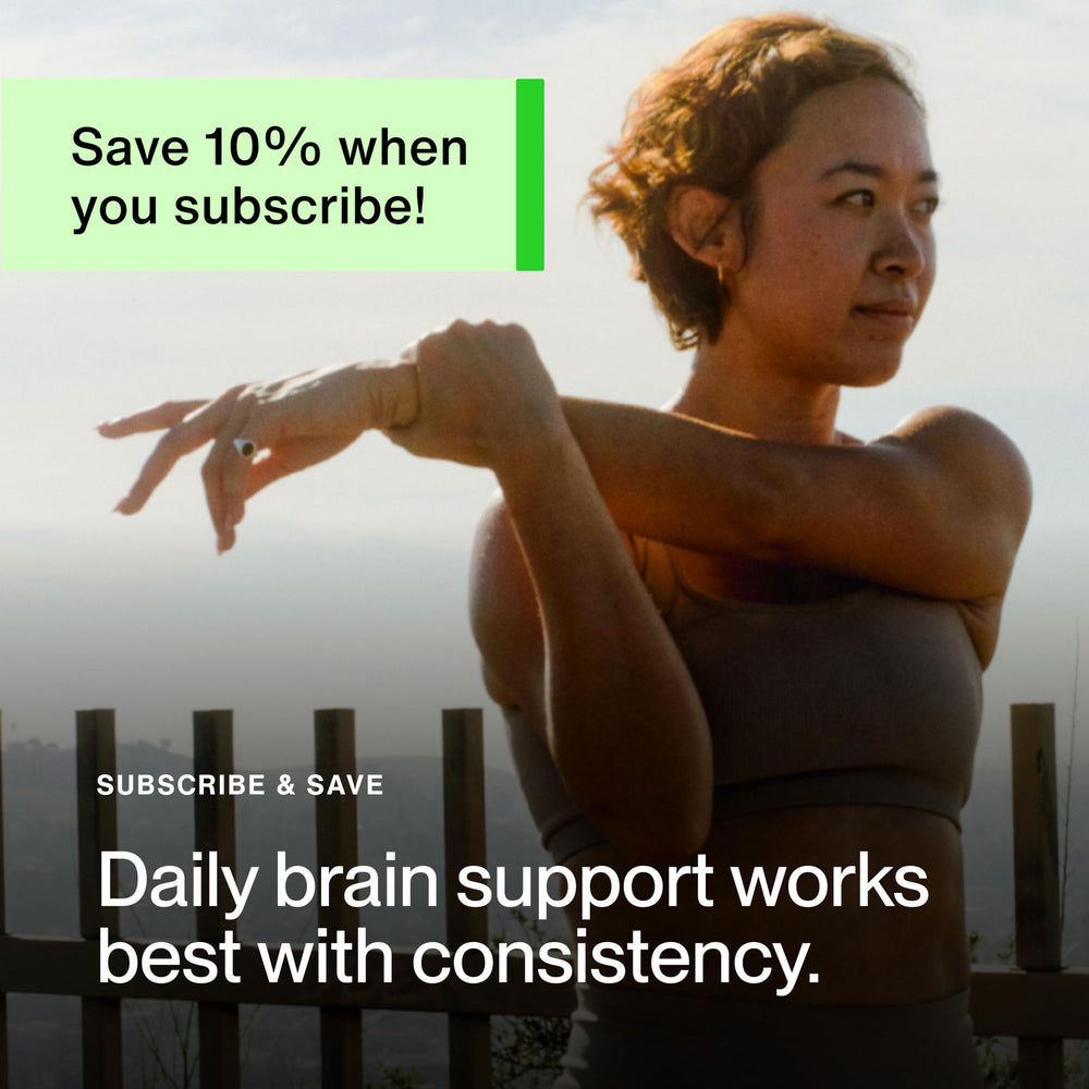 Momentous Magtein bottle beside glass of water for easy intake.