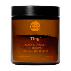 Moon Juice Ting bottle being opened for a mango flavor energy boost.