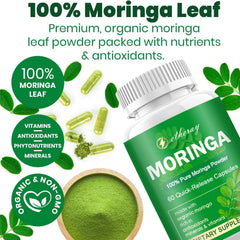 Green superfood bottle beside Moringa leaves