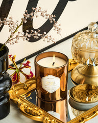 Ambient candle glow highlighting the shiny wax cup