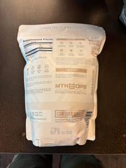 Product packaging and a glass of coffee with collagen stirred in
