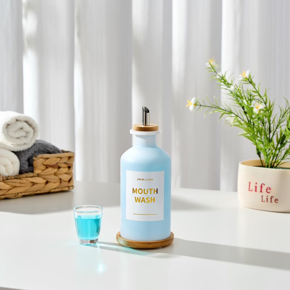 Minimalist bathroom display featuring white glass and bamboo tray