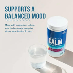 Scoop of Calm magnesium citrate powder being added to a glass of water
