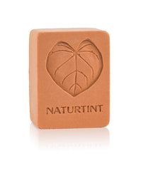 Naturtint shampoo bar orange close-up with creamy lather suggests gentle cleansing.