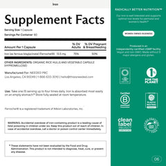 Pregnant woman holding iron supplement