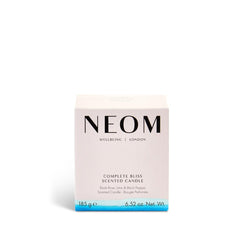 Neom Complete Bliss candle soft amber glow evokes warmth and calm during winding-down routines.