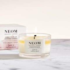 NEOM Complete Bliss travel candle packaging highlights premium wellbeing in a compact design.