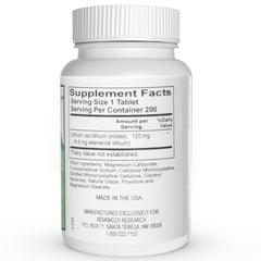 Close-up of a single 5 mg lithium orotate tablet on white background