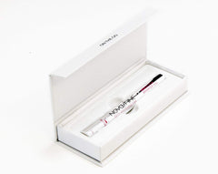 Close-up of whitening pen tip applying gel to tooth