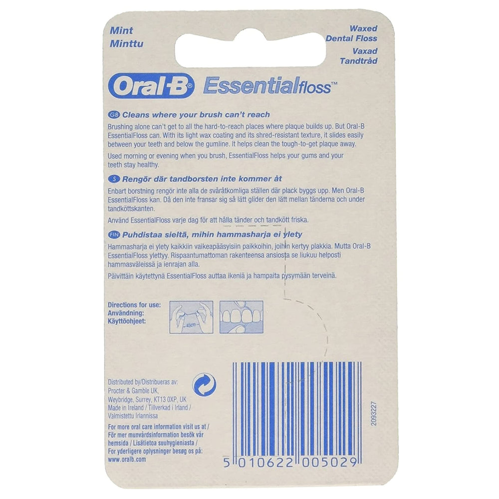 Close-up of Oral-B Essential Mint Floss waxed texture between teeth