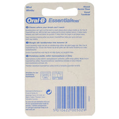 Close-up of Oral-B Essential Mint Floss waxed texture between teeth