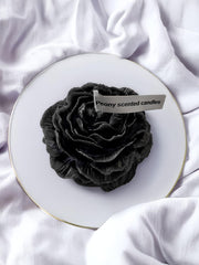 Peony flower-shaped candle in black with visible petal design