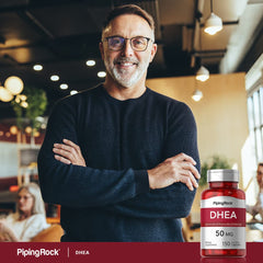 Hand holding Piping Rock DHEA capsule, shows easy swallow and daily convenience