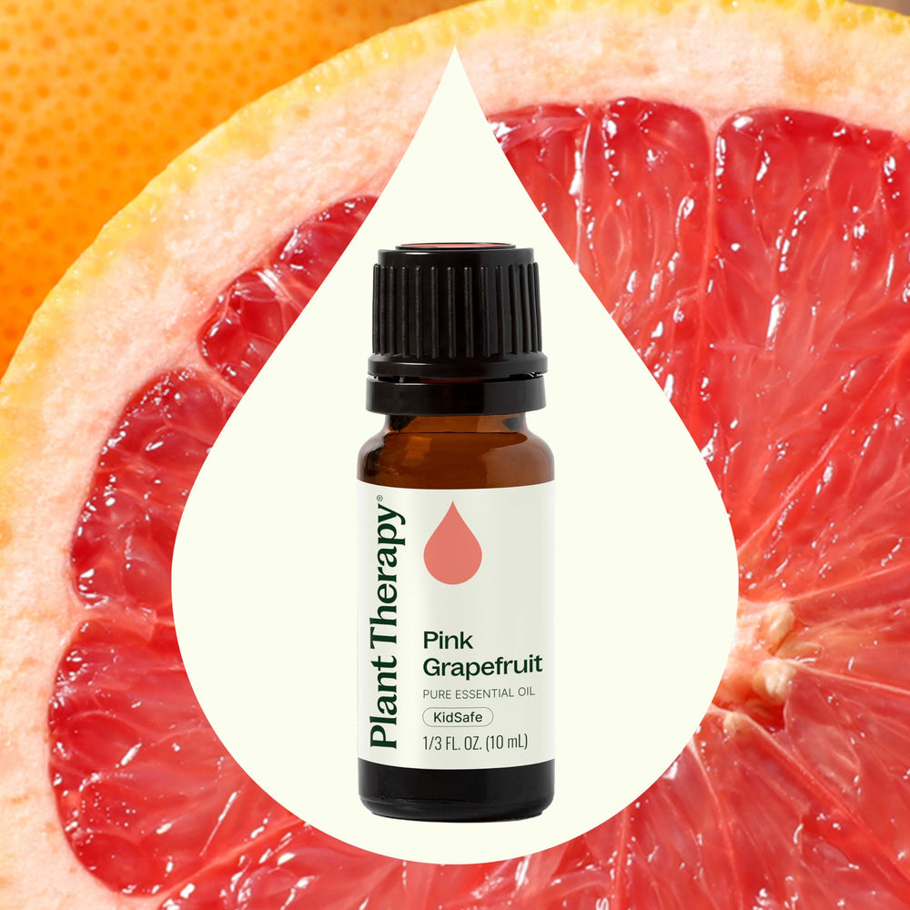 Amber bottle with grapefruit slices and sunlit background