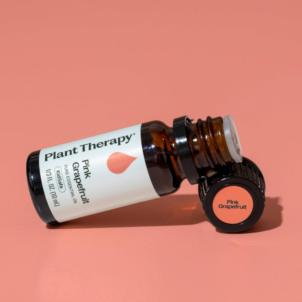 Hands diluting grapefruit essential oil for skincare