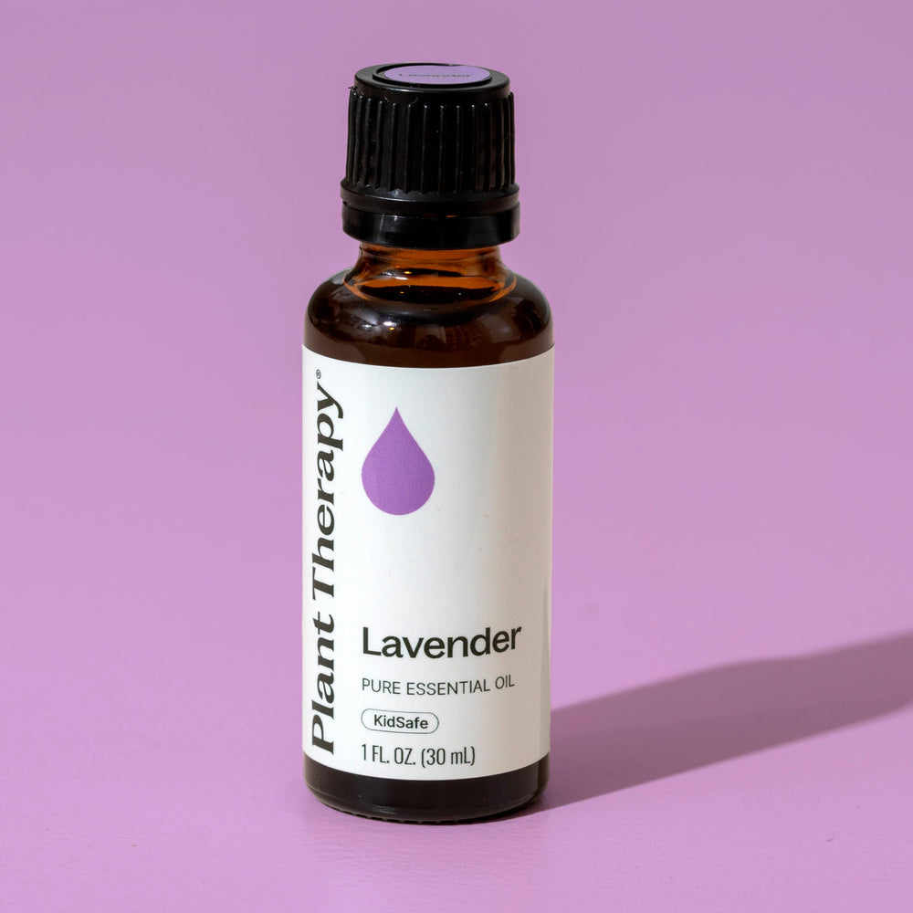 Lavender essential oil bottle with 30 mL label on a wooden surface
