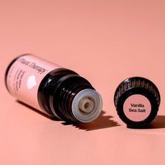 Carrier oils and Vanilla Sea Salt essential oil bottle on a wooden surface