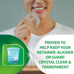 Dentures soaking in Polident cleansing solution