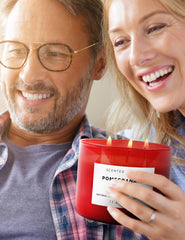 Side view of red glass jar with Pomegranate Noir Vanilla 3-Wick Candle