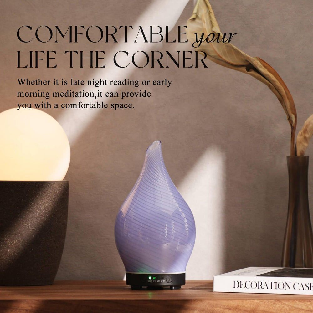 Porseme diffuser in a cozy bedroom/spa setting with purple glass