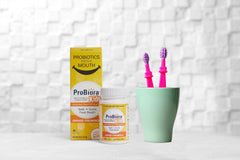 Three orange-creamsicle tablets representing a daily dose for kids