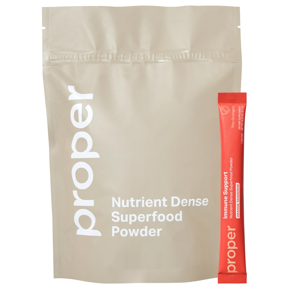 Proper Orange Immune Support powder – orange-tangerine flavor with scoop