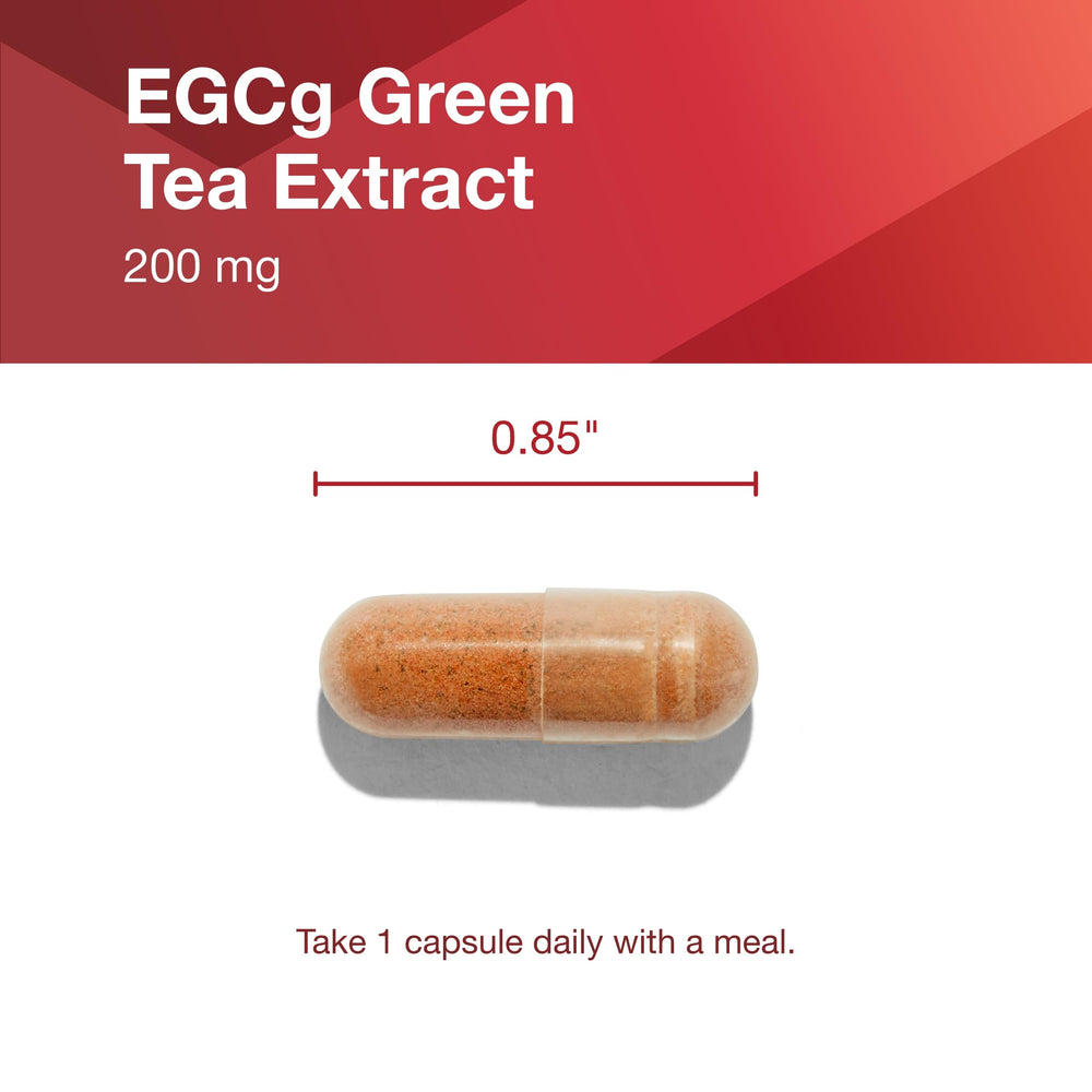 Two capsules in a hand with bottle in background