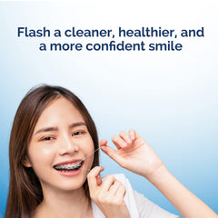 User smiling while using ProxySoft floss for daily oral hygiene