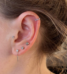 QWALIT waterproof earmuffs protect during piercing process.