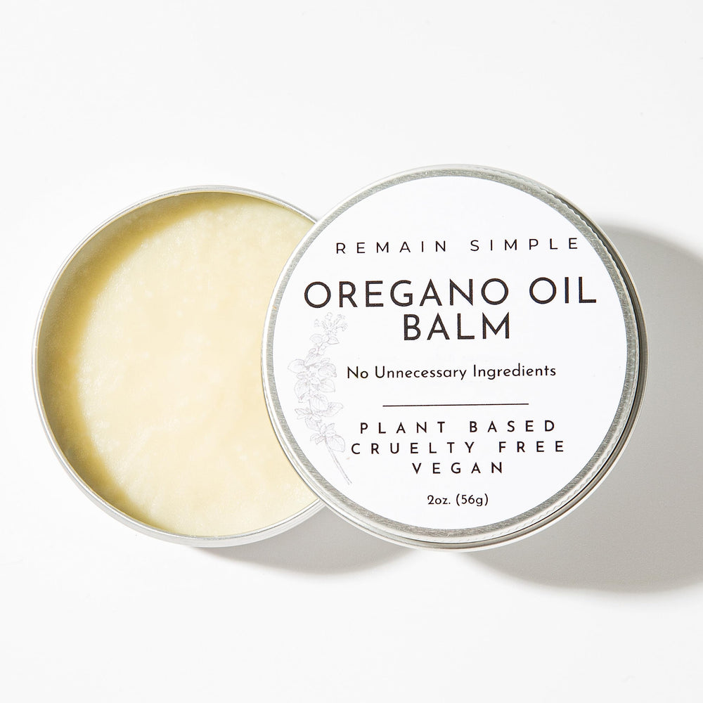 Remain Simple Oregano Oil Balm jar on wooden surface