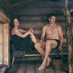 Pouring water to release birch aroma in sauna