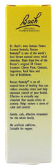 Close-up of Rescue Remedy bottle and ingredients on white background