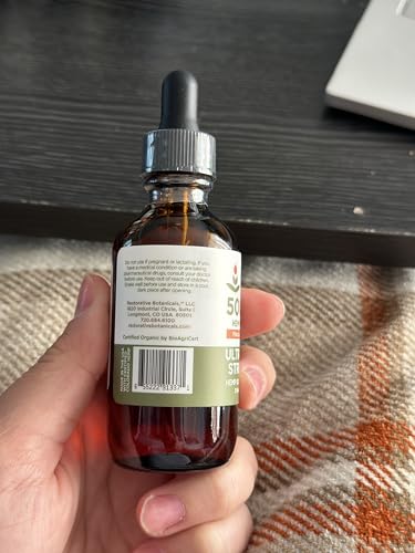 Dropper dispensing hemp oil from bottle