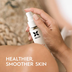 Hands applying massage oil to the skin for tightening