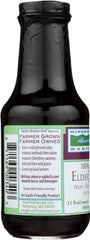 Glass bottle of Elderberry Juice with fresh elderberries nearby