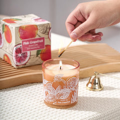 Gift-ready ROMIIE ZOI Pink Grapefruit candle in a home setting