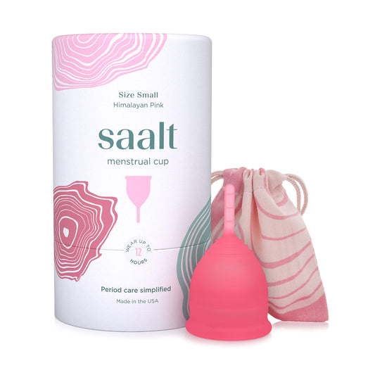 Saalt menstrual cup in hand shows compact reusable design for all day comfort.