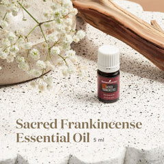 Close-up of dropper releasing sacred frankincense oil