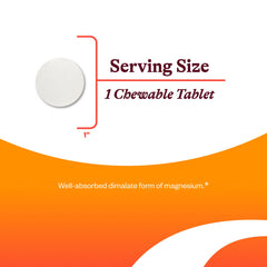 Chewable magnesium tablet next to a glass of water