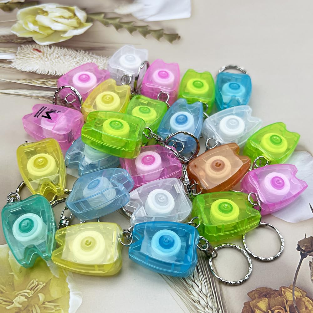 Assorted colors tooth-shaped floss keychains concept