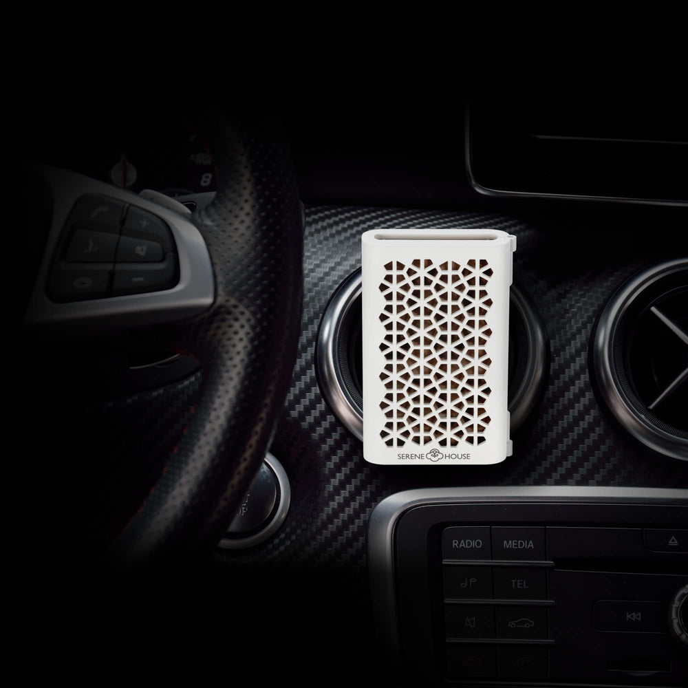 Serene House Puccini car vent clip white on dashboard for calming scents.