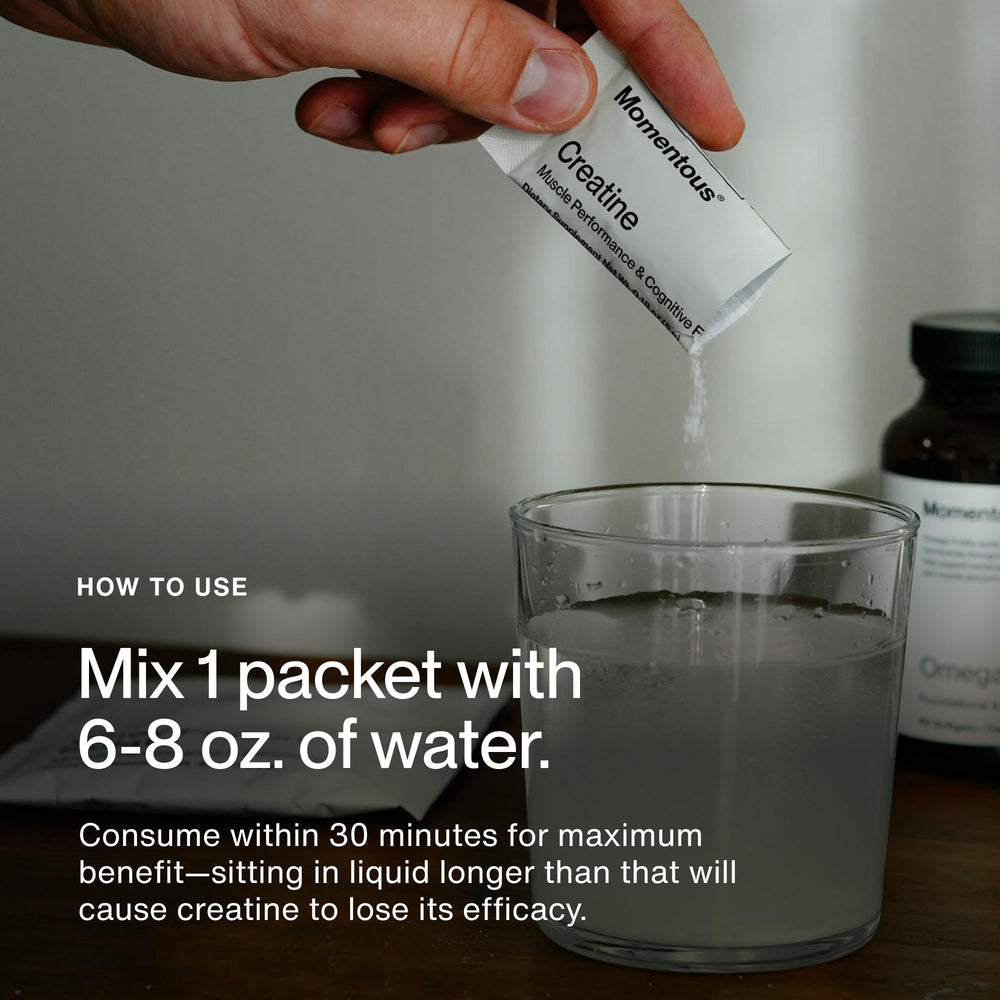 Serving Momentous creatine monohydrate powder in a glass