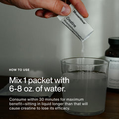 Serving Momentous creatine monohydrate powder in a glass
