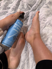 Lifestyle image of magnesium oil spray use for cramps or headaches