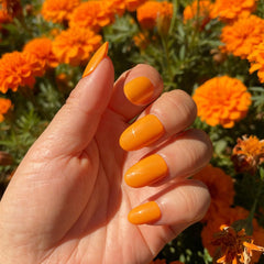 Shoindary orange press-on nails applying adhesive for durable wear