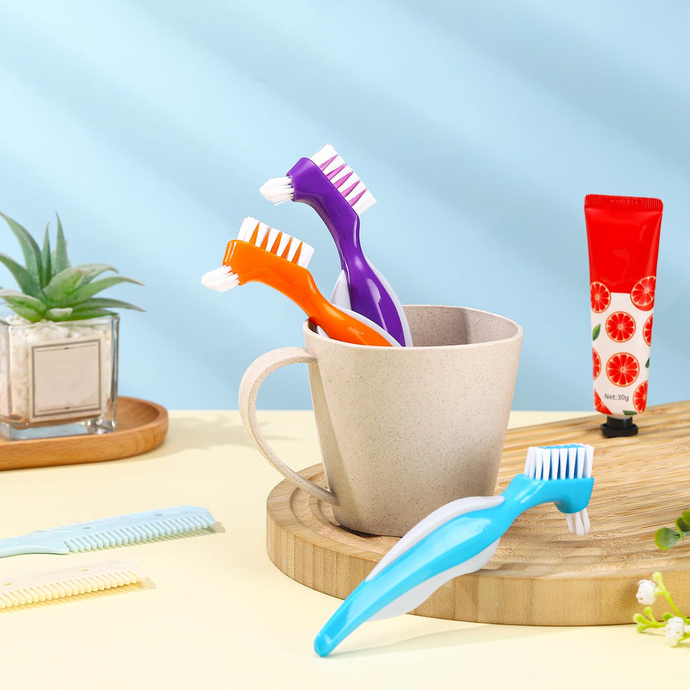 Six-pack denture cleaning brushes in Blue, Orange and Purple packaging